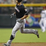 Miami Marlins' Justin Ruggiano rounds the bases after hitting a two-run home run against the Arizona Diamondbacks during the first inning of a baseball game, the first of a doubleheader, Wednesday, Aug. 22, 2012, in Phoenix. (AP Photo/Matt York)