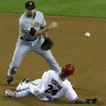 Pittsburgh Pirates' Neil Walker, top, forces out Arizona Diamondbacks' Chris Young (24) at second base during the second inning of a baseball game Monday, April 16, 2012, in Phoenix.(AP Photo/Ross D. Franklin)