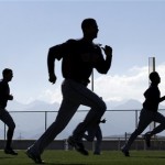 Cleveland Indians players run during baseball spring training in Goodyear, Ariz., Tuesday, Feb. 12, 2013. (AP Photo/Paul Sancya)