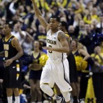 Michigan guard Trey Burke (3) celebrates a basket against Virginia Commonwealth in the second half of their third-round game of the NCAA college basketball tournament in Auburn Hills, Mich., Saturday March 23, 2013. Michigan won 78-53. (AP Photo/Paul Sancya)
