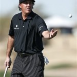 Phil Mickelson tosses his ball to his caddie while on the 15th green during the first round of the Waste Management Phoenix Open golf tournament Thursday, Jan. 31, 2013, in Scottsdale, Ariz. (AP Photo/Ross D. Franklin)
