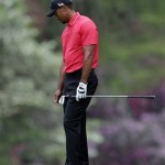 Tiger Woods reacts after his approach shot to the 14th hole during the fourth round of the Masters golf tournament Sunday, April 14, 2013, in Augusta, Ga. (AP Photo/Charlie Riedel)