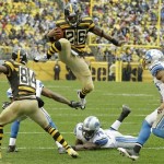 Pittsburgh Steelers running back Le'Veon Bell (26) leaps for more yardage as he tries to evade Detroit Lions strong safety Glover Quin (27) and the defense in the first half of an NFL football game in Pittsburgh, Sunday, Nov. 17, 2013. (AP Photo/Gene J. Puskar)