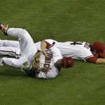 Arizona Diamondbacks' Joe Saunders, top, and Aaron Hill collide while the two were trying to field a bunt by Pittsburgh Pirates' Alex Presley during the fifth inning of a baseball game Monday, April 16, 2012, in Phoenix. Presley reached on an infield hit on the play.(AP Photo/Ross D. Franklin)