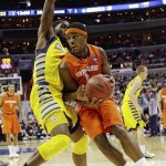 Syracuse forward C.J. Fair (5) drives past Marquette forward Jamil Wilson (0) during the second half of the East Regional final in the NCAA men's college basketball tournament, Saturday, March 30, 2013, in Washington. (AP Photo/Pablo Martinez Monsivais)