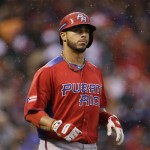 Puerto Rico's Mike Aviles runs in the rain after flying out against the Dominican Republic during the fourth inning of the championship2 game of the World Baseball Classic in San Francisco, Tuesday, March 19, 2013. (AP Photo/Eric Risberg)