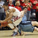  Arizona's Nick Johnson, left, and Rhode Island's Gilvydas Biruta, right, battles for a loose ball in the first half of an NCAA college basketball game, Tuesday, Nov. 19, 2013 in Tucson, Ariz. This is in the second round of the NIT. (AP Photo/Wily Low)