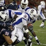 South Carolina State's Jalen Simmons (4) is dragged down by Arizona 's Dan Pettinato (90) during the first half of an NCAA college football game at Arizona Stadium in Tucson, Ariz., Saturday, Sept. 15, 2012. (AP Photo/Wily Low)
