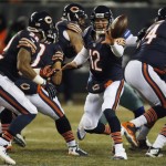 Chicago Bears quarterback Josh McCown (12) pitches the ball to Chicago Bears running back Matt Forte (22) during the first half of an NFL football game against the Dallas Cowboys, Monday, Dec. 9, 2013, in Chicago. (AP Photo/Charles Rex Arbogast)
