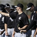 Chicago White Sox relief pitcher Brian Omogrosso holds out a grip on the baseball for teammates during baseball spring training in Phoenix, Thursday, Feb. 21, 2013. (AP Photo/Paul Sancya)