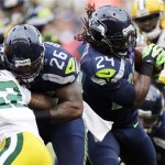 Seattle Seahawks running back Marshawn Lynch (24) carries the ball as fullback Michael Robinson (26) blocks Green Bay Packers safety Morgan Burnett (42) in the first half of an NFL football game, Monday, Sept. 24, 2012, in Seattle. (AP Photo/Ted S. Warren)