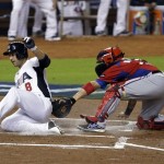 United States' Ryan Braun (8) slides safely into home to score on a double by Joe Mauer against Puerto Rico catcher Yadier Molina during the first inning of a second-round World Baseball Classic game, Tuesday, March 12, 2013, in Miami. (AP Photo/Wilfredo Lee)