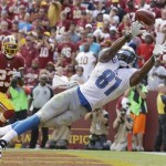 Detroit Lions tight end Brandon Pettigrew can't quite reach a Matthew Stafford pass in the end zone as Washington Redskins cornerback DeAngelo Hall watches in the background during the first half of a NFL football game in Landover, Md., Sunday, Sept. 22, 2013. (AP Photo/Alex Brandon)