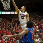 Arizona's Nick Johnson (13) lays up the ball around Florida's Mike Rosario (3) during the second half of an NCAA college basketball game at McKale Center in Tucson, Ariz., Saturday, Dec. 15, 2012. Arizona won 65-64. (AP Photo/Wily Low)
