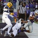  Kansas State wide receiver Tyler Lockett, right, catches a touchdown pass while covered by West Virginia safety Darwin Cook, left, and cornerback Ishmael Banks during the second half of an NCAA college football game in Manhattan, Kan., Saturday, Oct. 26, 2013. Kansas State won 35-12. (AP Photo/Orlin Wagner)