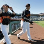 San Francisco Giants' Marco Scutaro, left, and Hector Sanchez take the field prior to a spring training baseball game against the Chicago White Sox, Monday, Feb. 25, 2013, in Scottsdale, Ariz. (AP Photo/Matt York)