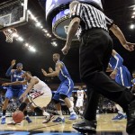Arizona forward Derrick Williams loses the ball as Memphis forward Will Coleman, left and Wesley Witherspoon defend in the second half of a West Regional NCAA tournament second-round college basketball game, Friday, March 18, 2011 in Tulsa, Okla. (AP Photo/Charlie Riedel)