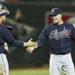 Atlanta Braves' Eric O'Flaherty, right, smiles as he shakes hands with catcher Brian McCann (16) after the ninth inning of a baseball game against the Arizona Diamondbacks, on Monday, May 13, 2013, in Phoenix. The Braves beat the Diamondbacks 10-1. (AP Photo/Ross D. Franklin)