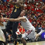Long Beach State's Mike Caffey (5) shoots over Arizona's T.J. McConnell, right, in the first half of an NCAA college basketball game, Monday, Nov. 11, 2013 in Tucson, Ariz. (AP Photo/Wily Low)