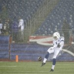 Indianapolis Colts punter Pat McAfee warms up in the rain before an AFC divisional NFL playoff football game against the New England Patriots in Foxborough, Mass., Saturday, Jan. 11, 2014. (AP Photo/Matt Slocum)