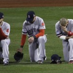  Boston Red Sox's Daniel Nava, left to right, Jacoby Ellsbury and Shane Victorino kneel in the outfield during a pitching change in the seventh inning of Game 3 of baseball's World Series against the St. Louis Cardinals Saturday, Oct. 26, 2013, in St. Louis. (AP Photo/David J. Phillip)