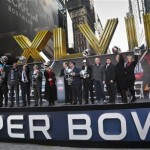Officials from New York, New Jersey, and Arizona raise souvenir football helmets during a ceremony to pass official hosting duties of next year's Super Bowl to representatives from Arizona, Saturday Feb. 1, 2014, on New York's Super Bowl Boulevard. (AP Photo/Bebeto Matthews)