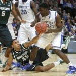 Michigan State guard Denzel Valentine (45) reaches for a rebound against Kentucky forward Alex Poythress during the first half of an NCAA college basketball game Tuesday, Nov. 12, 2013, in Chicago. (AP Photo/Charles Rex Arbogast)