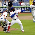 Dominican Republic relief pitcher Fernando Rodney (58), catcher Carlos Santana, left, and Hanley Ramirez (13) celebrate their 5-4 win over Italy at the World Baseball Classic game in Miami, Tuesday, March 12, 2013. (AP Photo/Alan Diaz)