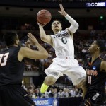 Miami's Shane Larkin (0) shoots between Pacific's Tony Gill (33) and Lorenzo McCloud (11) during the first half of a second-round game of the NCAA college basketball tournament Friday, March 22, 2013, in Austin, Texas. (AP Photo/David J. Phillip)