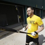 Pittsburgh Pirates catcher Russell Martin makes his way to the batting cage during a baseball spring training unofficial workout Monday, Feb. 11, 2013, in Bradenton, Fla. (AP Photo/Charlie Neibergall)
