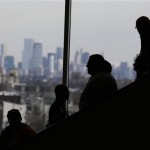 Fans make their way around the Prudential Center as the New York city skyline is seen during media day for the NFL Super Bowl XLVIII football game Tuesday, Jan. 28, 2014, in Newark, N.J. (AP Photo/Charlie Riedel)
