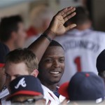 Atlanta Braves' Justin Upton is congratulated in the dugout after hitting a home run against the Miami Marlins during the fourth inning of an exhibition spring training baseball game Monday, Feb. 25, 2013, in Kissimmee, Fla. (AP Photo/David J. Phillip)