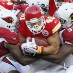 Kansas City Chiefs running back Peyton Hillis (40) is tackled by Arizona Cardinals linebacker Reggie Walker (56) and defensive end Ronald Tailey (93) during the first half an NFL preseason football game in Kansas City, Mo., Friday, Aug. 10, 2012. (AP Photo/Colin E. Braley)