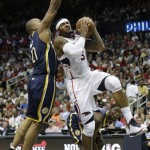 Atlanta Hawks small forward Josh Smith (5) heads to the hoop under pressure from Indiana Pacers power forward David West (21) during the second half in Game 4 of their first-round NBA basketball playoff series game, Monday, April 29, 2013 in Atlanta. (AP Photo/John Bazemore)