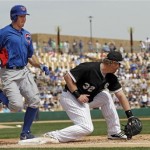 Chicago Cubs' Brian Bogusevic beats the throw to Chicago White Sox first baseman Adam Dunn (32) to reach safely on a fielding error in the fourth inning of an exhibition spring training baseball game Friday, March 15, 2013, in Glendale, Ariz. (AP Photo/Mark Duncan)