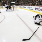 Anaheim Ducks' Daniel Winnik (34) lies on the ice after a being hit into the boards against the Phoenix Coyotes during the first period of an NHL hockey game, Monday, March 4, 2013, in Glendale, Ariz. (AP Photo/Matt York)