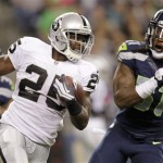  Oakland Raiders' Mike Goodson, left, is chased by Seattle Seahawks' Bruce Irvin in the first half of a preseason NFL football game Thursday, Aug. 30, 2012 in Seattle. (AP Photo/Stephen Brashear)