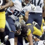 Tennessee Titans running back Jackie Battle (22) scores a touchdown in front of Pittsburgh Steelers strong safety Troy Polamalu (43) in the second quarter of an NFL football game in Pittsburgh, Sunday, Sept. 8, 2013. (AP Photo/Gene J. Puskar)