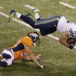 Denver Broncos' Tony Carter hits Seattle Seahawks' Jermaine Kearse during the second half of the NFL Super Bowl XLVIII football game Sunday, Feb. 2, 2014, in East Rutherford, N.J. (AP Photo/Charlie Riedel)