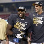 Central Florida head coach George O'Leary, left, watches as players Terrance Plummer, middle, and Blake Bortles, right, smile at the crowd and teammates after a Fiesta Bowl NCAA college football game win against Baylor Wednesday, Jan. 1, 2014, in Glendale, Ariz. Central Florida defeated Baylor 52-42. (AP Photo/Ross D. Franklin)