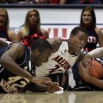 Arizona's Josiah Turner (11) battle for a loose ball against Northern Arizona's Durrell Norman (34) and Ephraim Ekanem (42) during the first half of an NCAA college basketball game at McKale Center in Tucson, Ariz., Saturday, Dec. 3, 2011. (AP Photo/Wily Low)