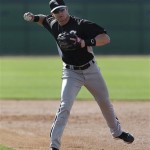 Chicago White Sox second baseman Gordon Beckham throws during spring training baseball in Phoenix, Thursday, Feb. 21, 2013. (AP Photo/Paul Sancya)