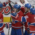Montreal Canadiens' Brendan Gallagher (11) celebrates with teammates Jarred Tinordi (42), Brandon Prust (8) and Francis Bouillon (55) after scoring against the Ottawa Senators during second-period NHL hockey Game 2 first-round playoff action in Montreal, Friday, May 3, 2013. (AP Photo/The Canadian Press, Graham Hughes)