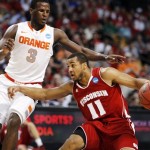 Wisconsin guard Jordan Taylor (11) drives against Syracuse guard Dion Waiters (3) in the first half of an East Regional semifinal game in the NCAA men's college basketball tournament, Thursday, March 22, 2012, in Boston. (AP Photo/Michael Dwyer)