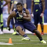 Syracuse running back Jerome Smith runs a drill at the NFL football scouting combine in Indianapolis, Sunday, Feb. 23, 2014. (AP Photo/Michael Conroy)