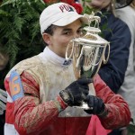 Joel Rosario kisses the trophy after riding Orb to victory in the 139th Kentucky Derby at Churchill Downs Saturday, May 4, 2013, in Louisville, Ky. (AP Photo/David Goldman)
