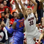 Florida's Michael Frazier II (20) tries to shoot over Arizona's Grant Jerrett(33) during the first half of an NCAA college basketball game at McKale Center in Tucson, Ariz., Saturday, Dec. 15, 2012. (AP Photo/Wily Low)
