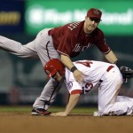 St. Louis Cardinals' Shane Robinson, bottom, is out at second as Arizona Diamondbacks second baseman Willie Bloomquist turns the double play during the second inning of a baseball game on Wednesday, June 5, 2013, in St. Louis. (AP Photo/Jeff Roberson)