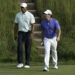 Tiger Woods, left, and Rory McIlroy, of Northern Ireland, walk to the 17th green during the third round of the U.S. Open golf tournament at Merion Golf Club, Saturday, June 15, 2013, in Ardmore, Pa. (AP Photo/Julio Cortez)
