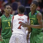 Louisville's Russ Smith (2) is congratulated by Oregon's Dominic Artis (1) and Damyean Dotson (21) after Louisville's 77-69 win over Oregon in an regional semifinal in the NCAA college basketball tournament, Friday, March 29, 2013, in Indianapolis. (AP Photo/Michael Conroy)